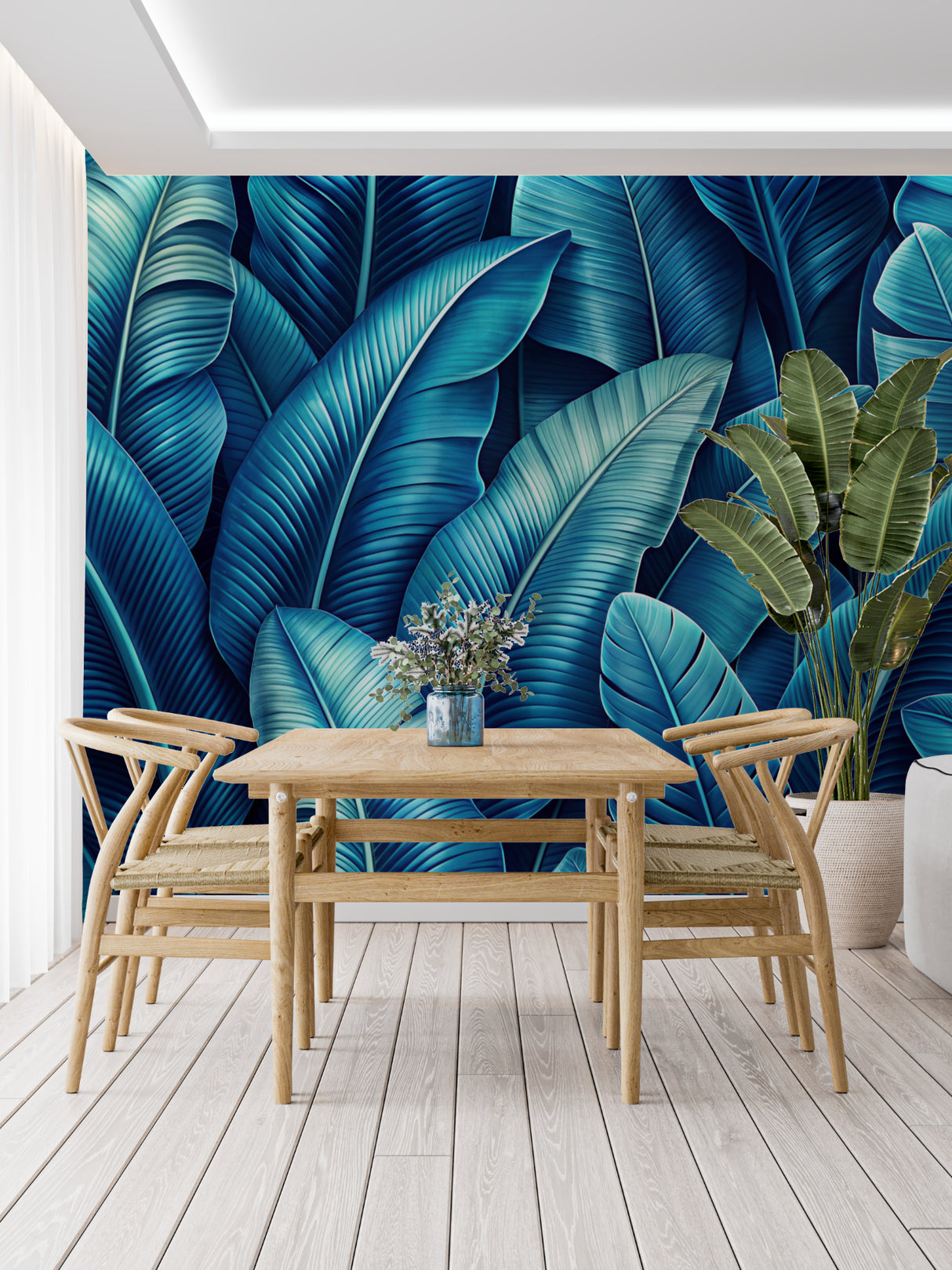 Tropical leaf wallpaper in modern living room showing blue banana leaves pattern against white sofa