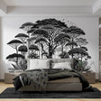 Black and white tropical forest wallpaper creating depth in modern living room with minimal furniture