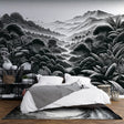 Black and white tropical forest wallpaper creating depth in a modern living room with minimal furniture