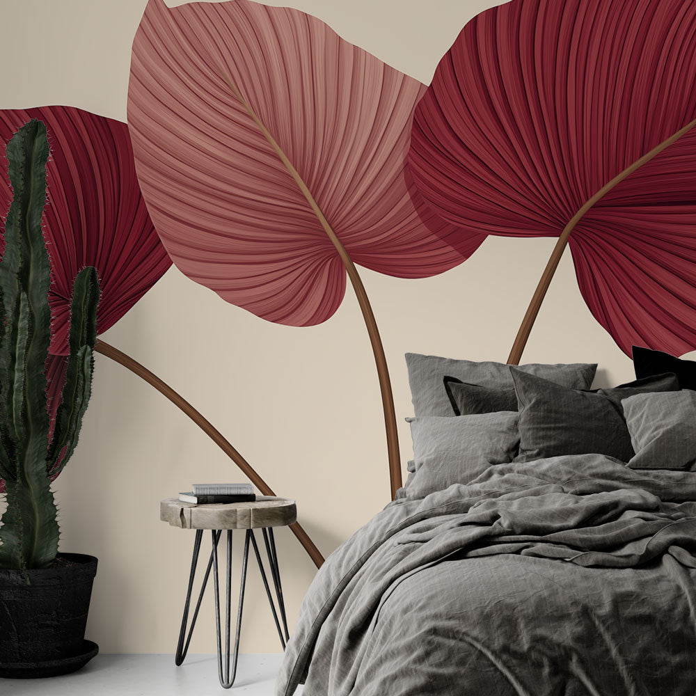 Burgundy and pink tropical leaf wallpaper creating a cozy atmosphere in a modern living room with natural light