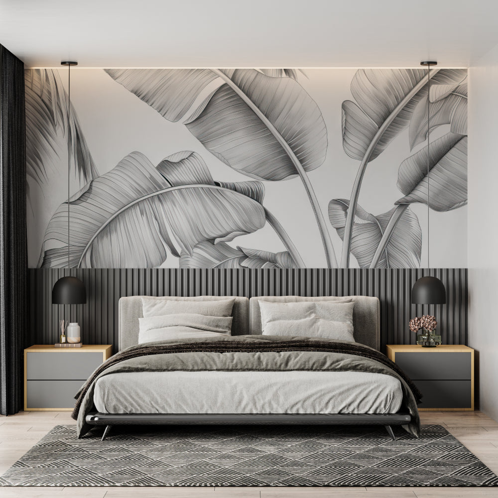 Black and white tropical leaf wallpaper creating drama in modern living room with grey sofa