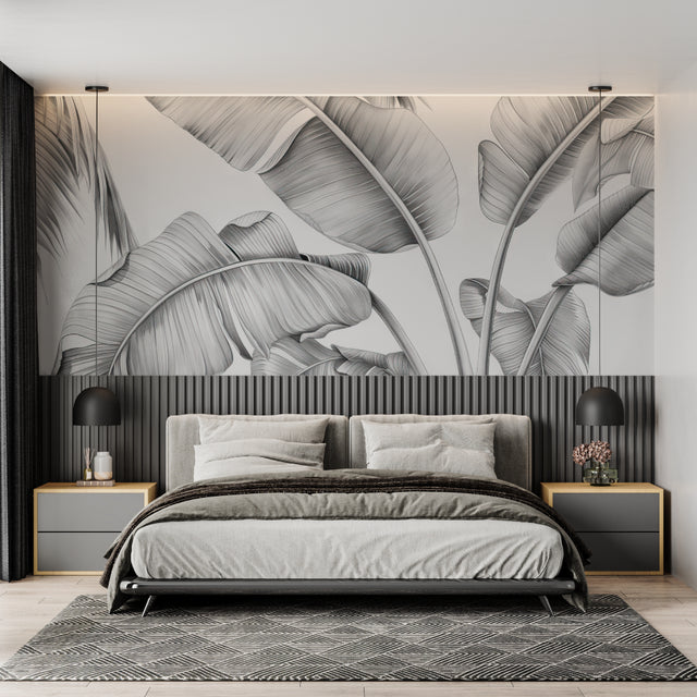 Black and white tropical leaf wallpaper creating drama in modern living room with grey sofa