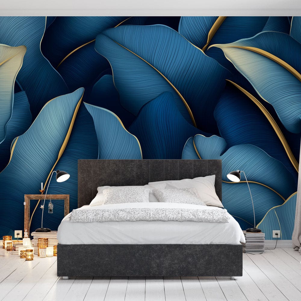 Blue and gold tropical leaf wallpaper creating luxury atmosphere in modern living room with grey sofa and brass accents