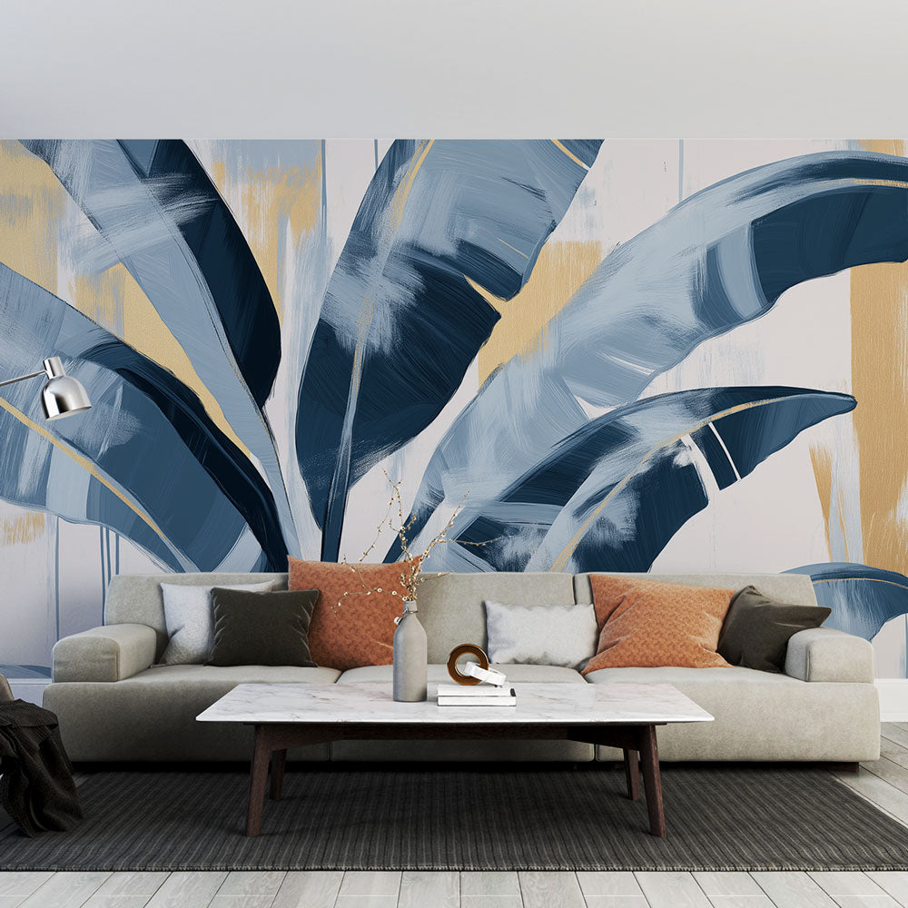 Blue and gold tropical leaf wallpaper creating a stunning focal point in a modern living room with high ceilings