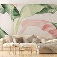 Tropical leaf wallpaper with pink accents in modern living room, creating a fresh and peaceful atmosphere