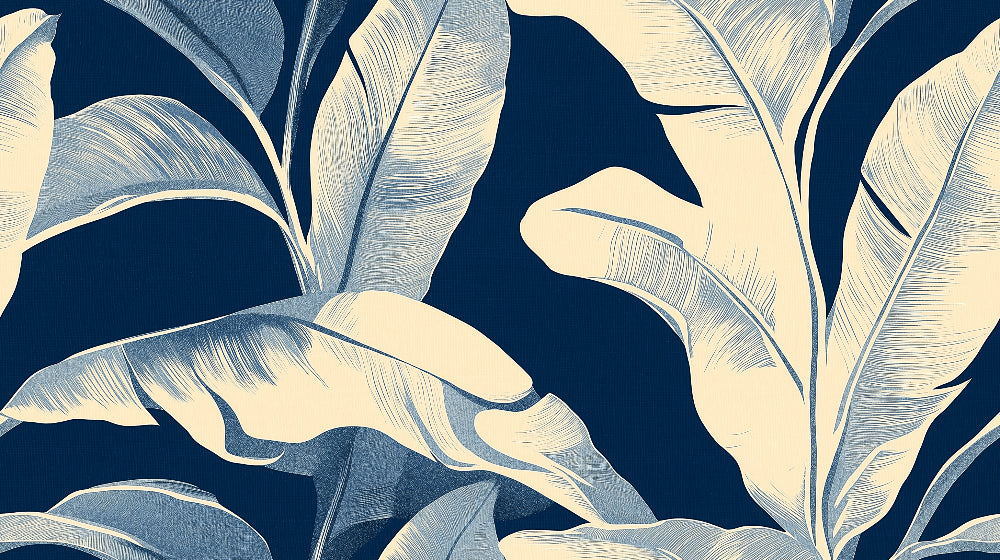 Tropical leaf wallpaper with white banana leaves on navy creating depth in a modern dining room setting