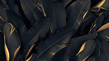 Black and gold tropical leaf wallpaper creating a luxurious backdrop in a modern living room with soft lighting