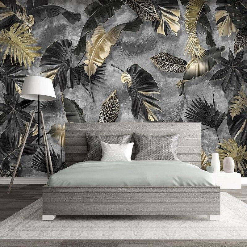 Black and gold tropical leaf mural creating drama in master bedroom with luxury decor