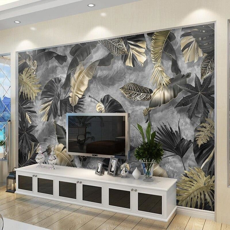 Home office space with black and gold botanical wallpaper creating sophisticated atmosphere