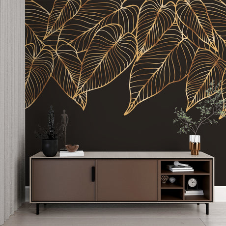 Tropical black and gold leaf wallpaper in modern living room with grey sofa and natural light
