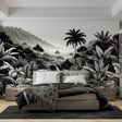 Black and white tropical jungle mural wallpaper creating depth in a modern living room with minimalist furniture
