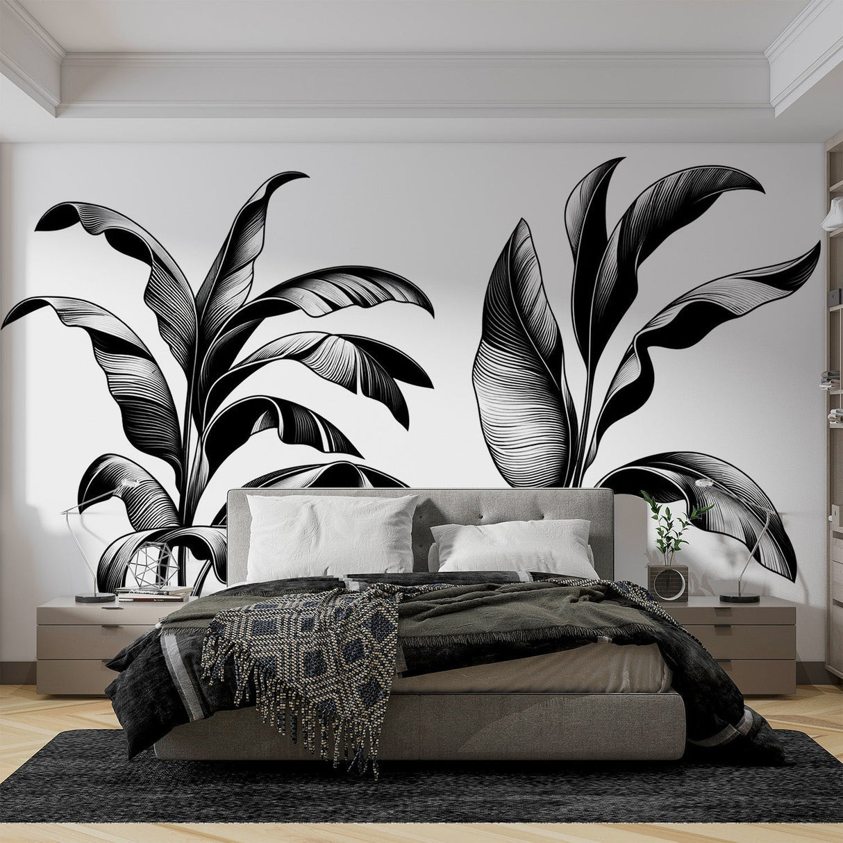 Black and white tropical leaf wallpaper creating a bold statement in a modern minimalist living room with white furniture