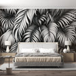 Black and white Monstera leaf wallpaper creating dramatic contrast in modern living room with minimalist furniture