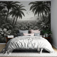 Black and white tropical palm wallpaper creating a dramatic statement wall in a modern living room with minimalist furniture