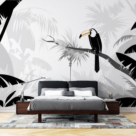 Tropical bird wallpaper with black and white toucan design creating drama in a modern living room with minimalist furniture