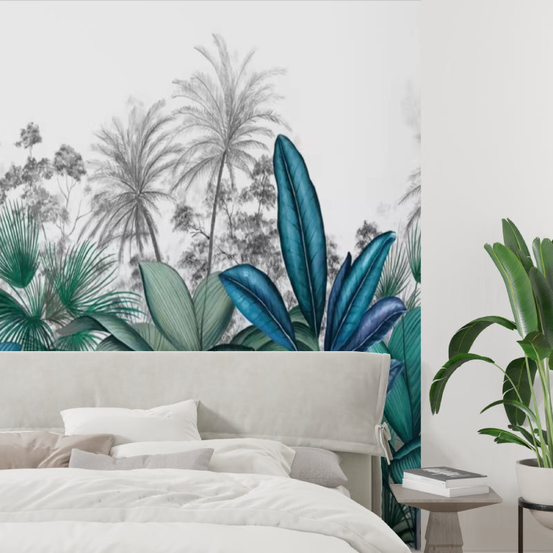 Palm and banana leaf mural creating depth in a dining room