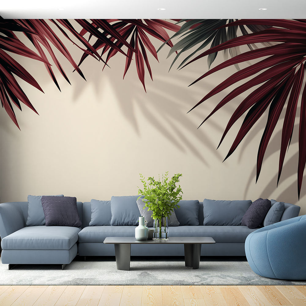 Burgundy tropical palm leaf wallpaper creating an elegant atmosphere in a modern living room with cream accents
