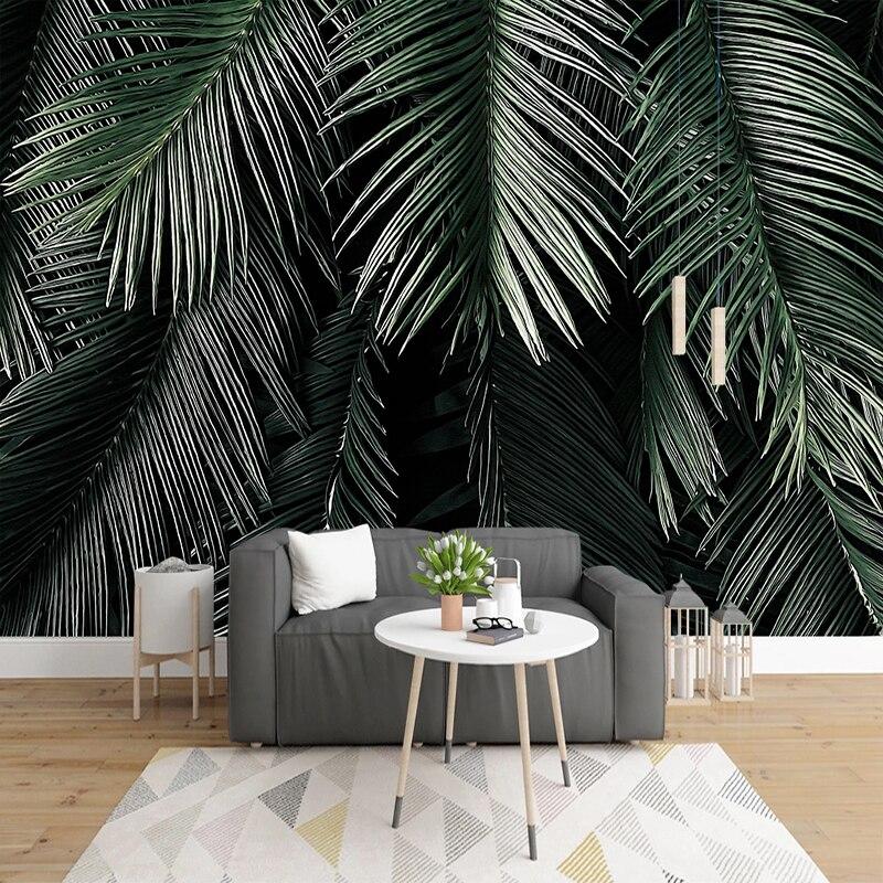 Tropical palm leaves wallpaper in modern living room with grey sofa and natural light