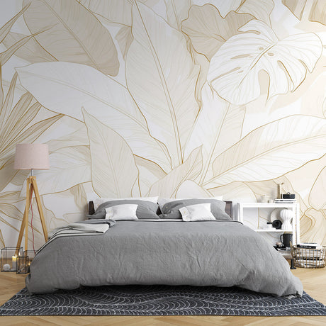 Tropical leaf wallpaper with white and gold design creating an elegant atmosphere in a modern living room