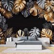 Tropical gold and black Monstera leaf wallpaper in modern dining room with pendant lights