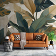 Tropical monstera leaf wallpaper creating a fresh atmosphere in a modern living room with golden accents