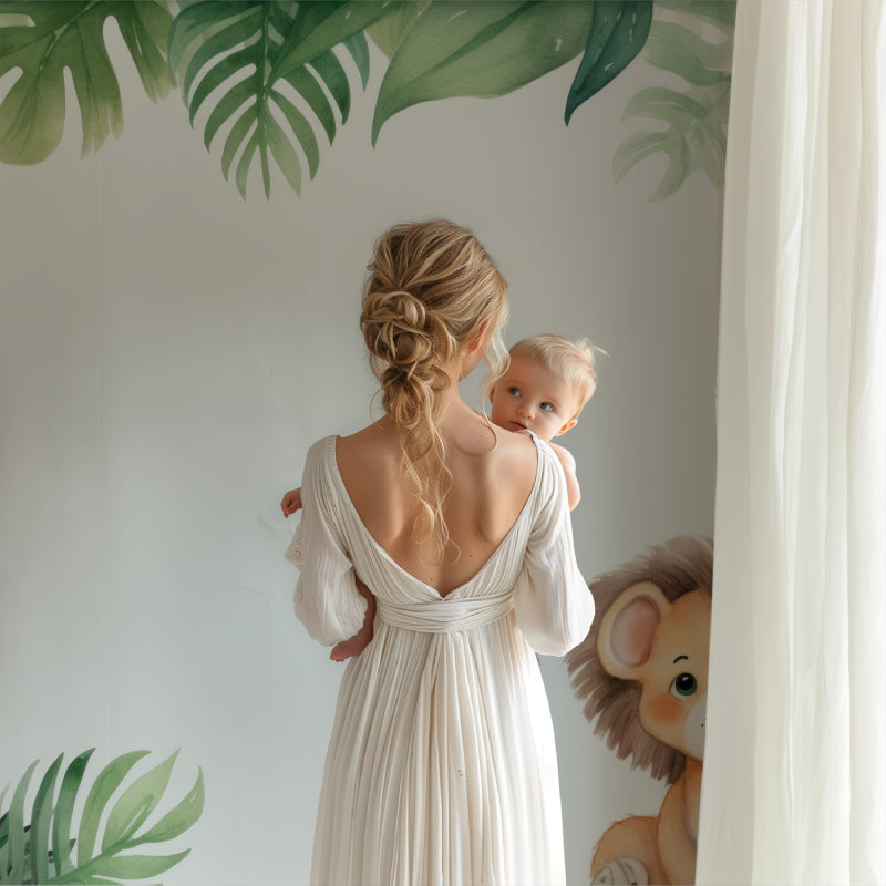 Kids bedroom featuring lion and monstera leaf wallpaper bringing jungle adventure feel