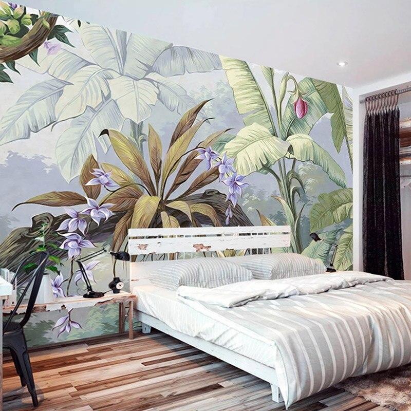 Tropical banana leaf wallpaper with purple orchids creating a peaceful atmosphere in a modern living room