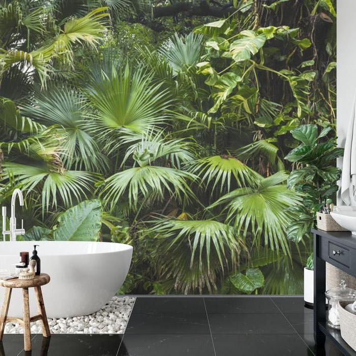 Tropical palm leaf wallpaper in modern living room showing green monstera and palm pattern