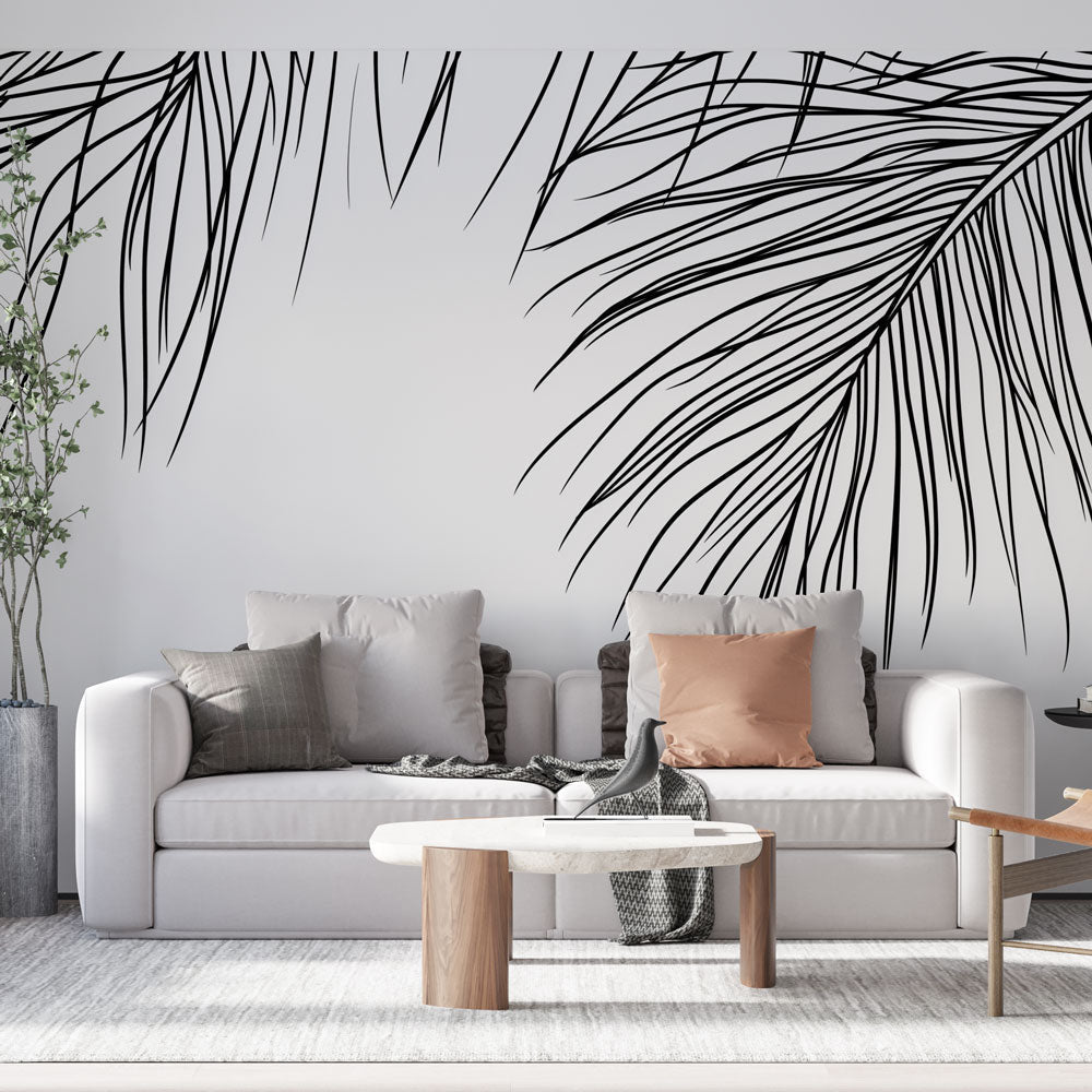 Minimalist palm leaf wallpaper creating a fresh modern look in a bright living room with white sofa and natural light