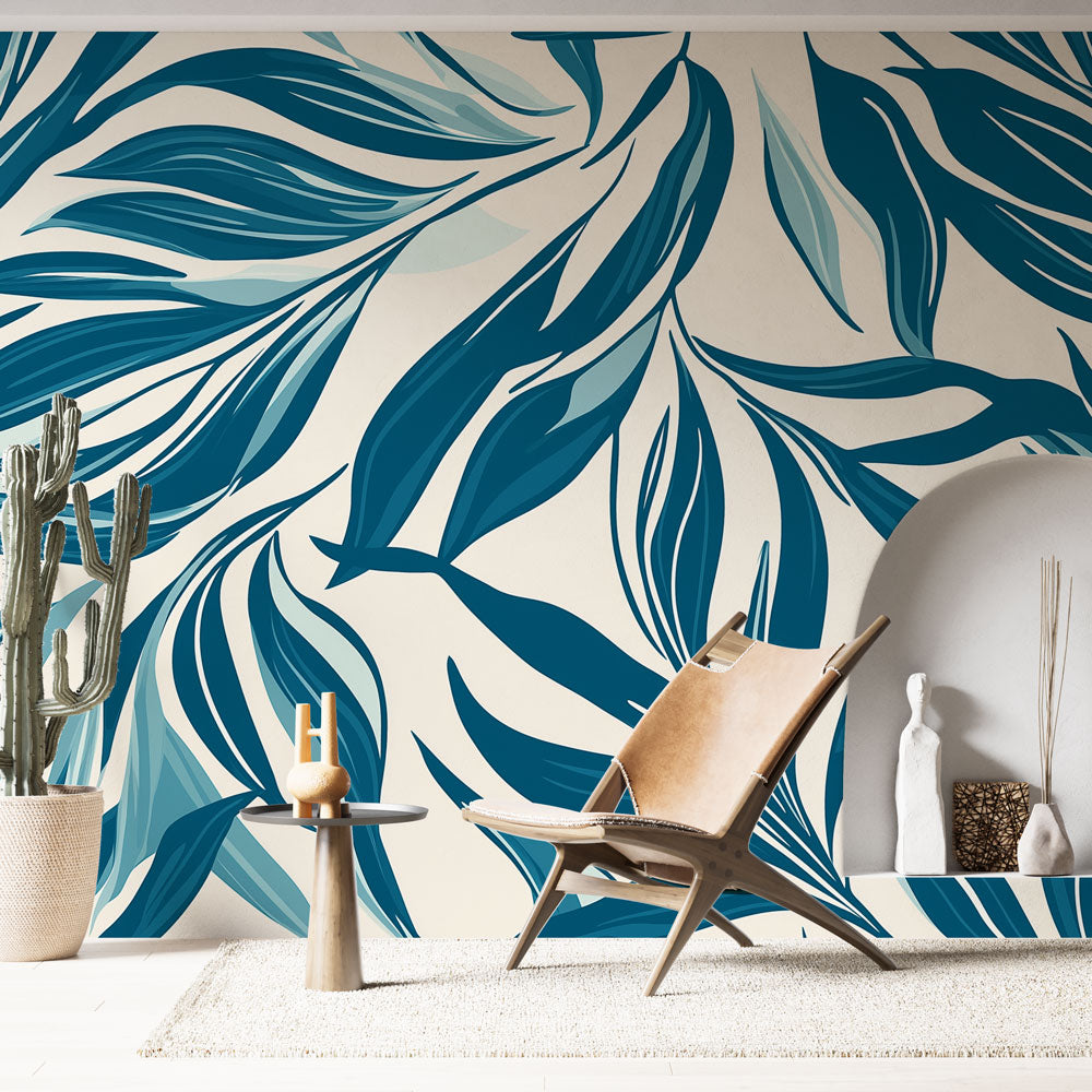 Modern blue tropical leaf wallpaper creating a stunning accent wall in a bright contemporary living room