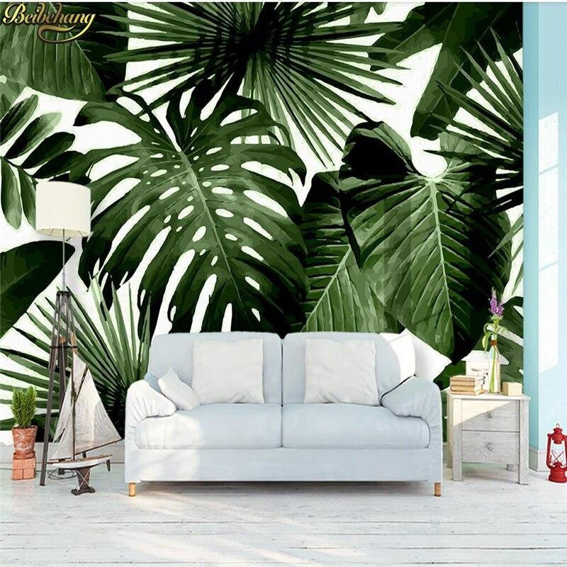 Tropical leaf wallpaper creating a fresh backdrop in modern living room with grey sofa