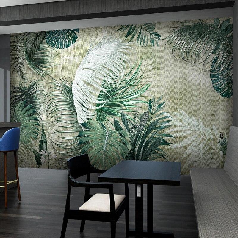 Entrance hall decorated with green tropical leaf wallpaper creating welcoming feel