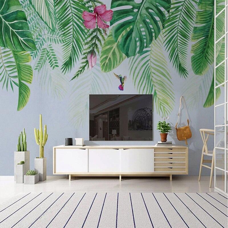 Botanical wallpaper with monstera leaves and hummingbird brightening up a cozy bedroom space