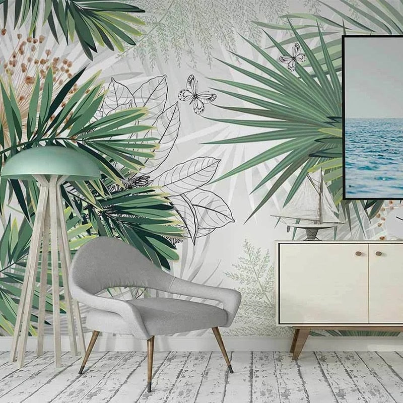 Botanical wall mural with palm leaves and butterflies brightening up a cozy bedroom space