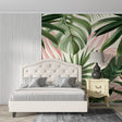 Tropical leaf wallpaper with pink and green monstera leaves in modern living room setting