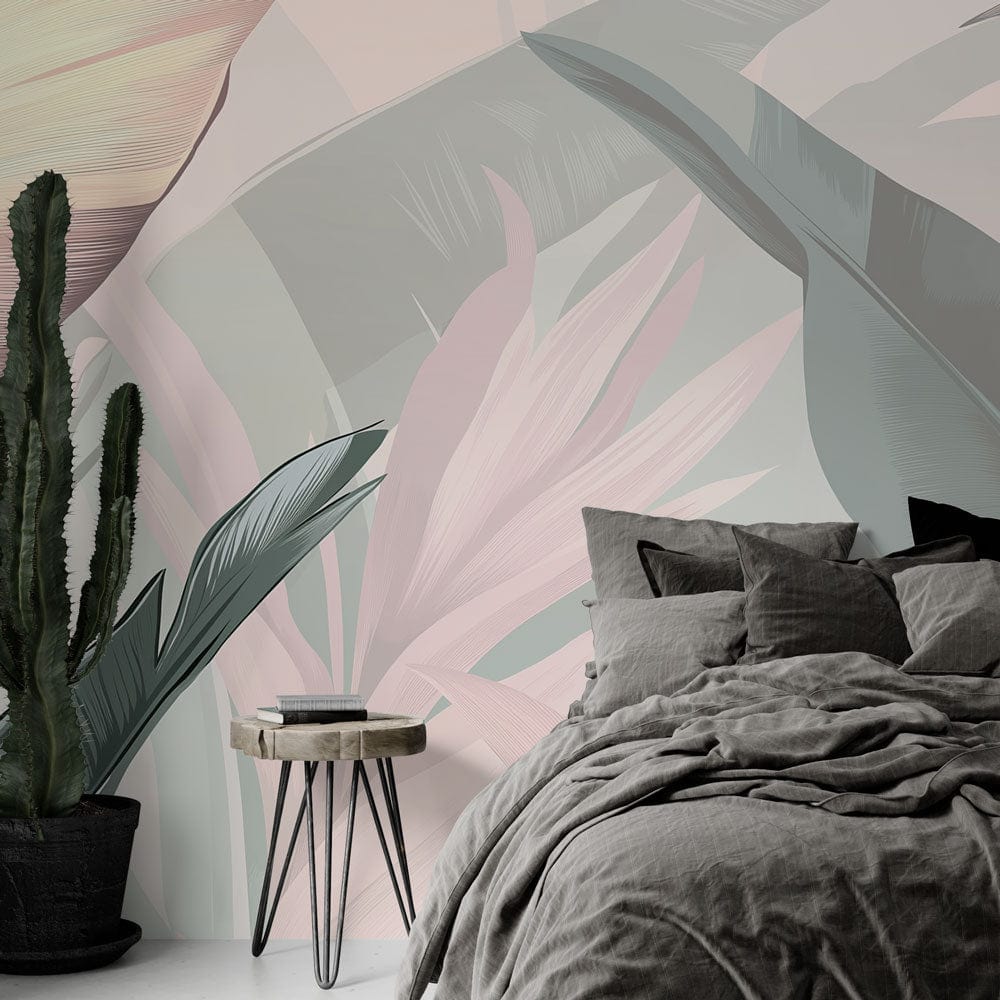 Tropical leaf wallpaper with pink and sage palm leaves creating a serene atmosphere in a modern living room