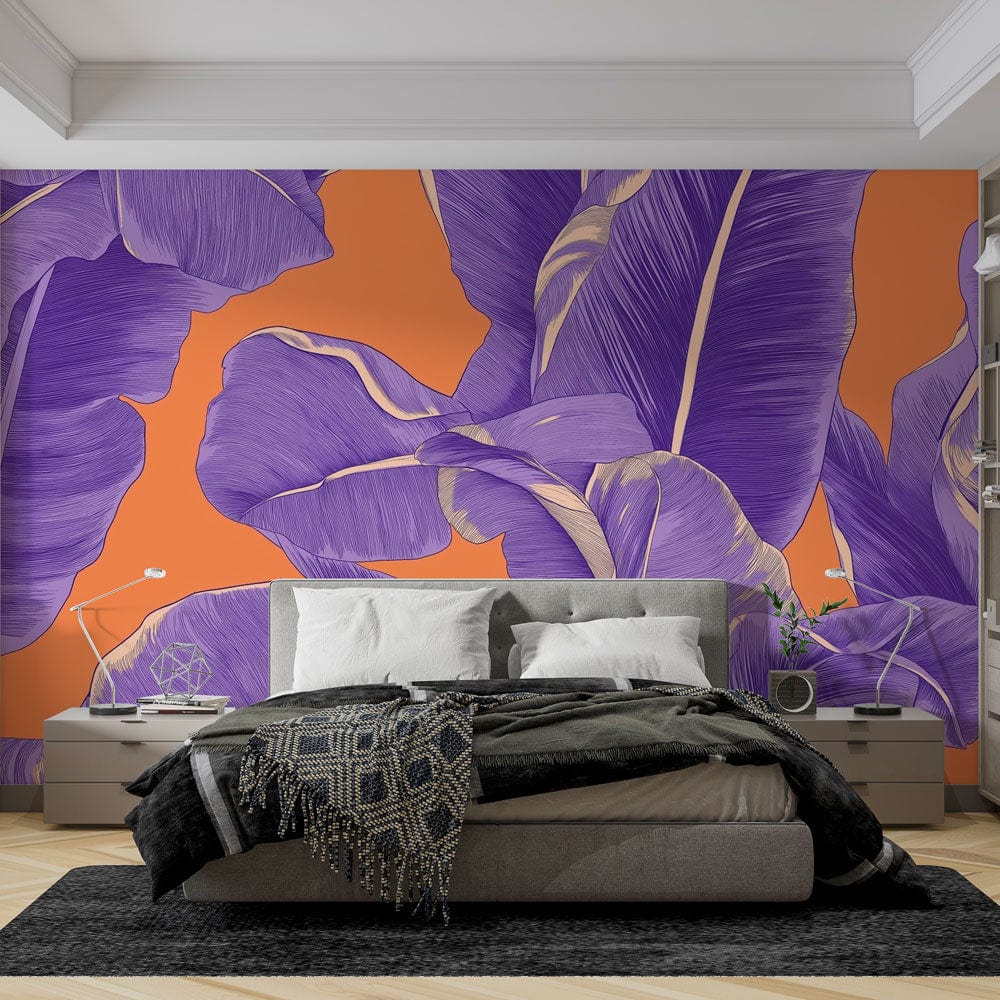 Tropical banana leaf wallpaper in purple and orange creating a bold statement wall in a modern living room setting