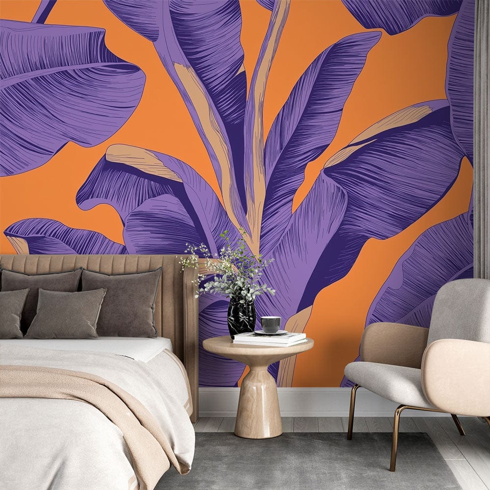 Tropical banana leaf wallpaper in purple and orange creating a stunning accent wall in a modern living room