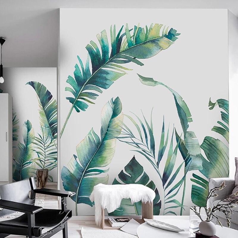 Tropical leaf wallpaper in bright modern living room showing watercolor banana leaves creating airy atmosphere