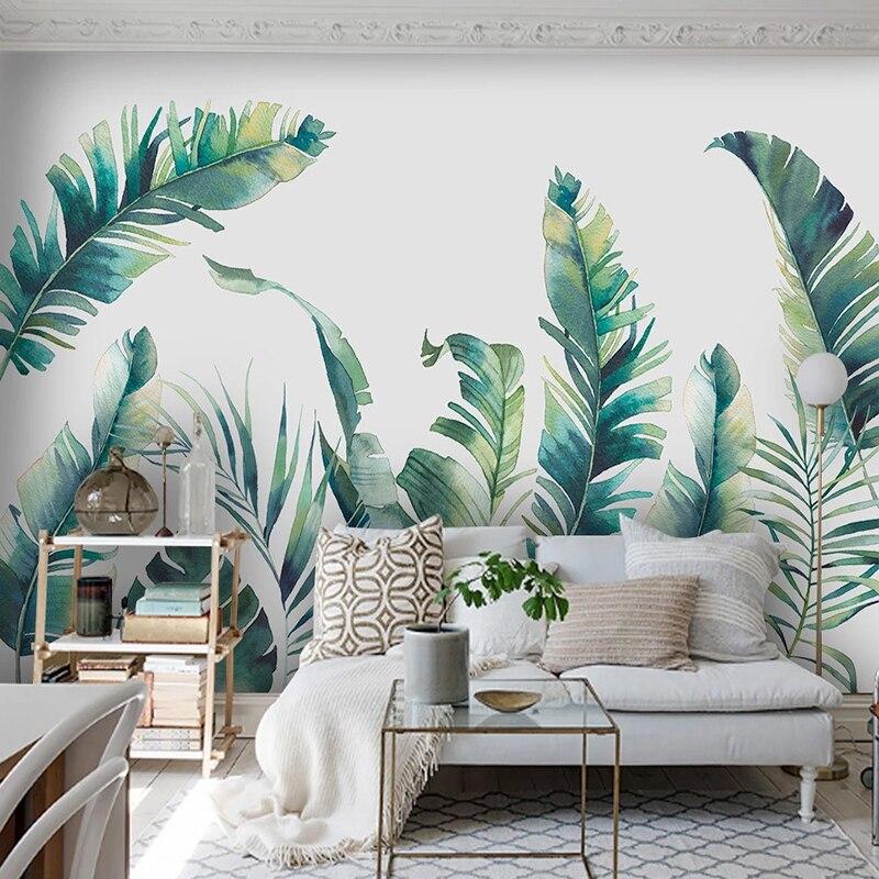 Botanical wall mural in home office showcasing fresh green banana leaves against white background