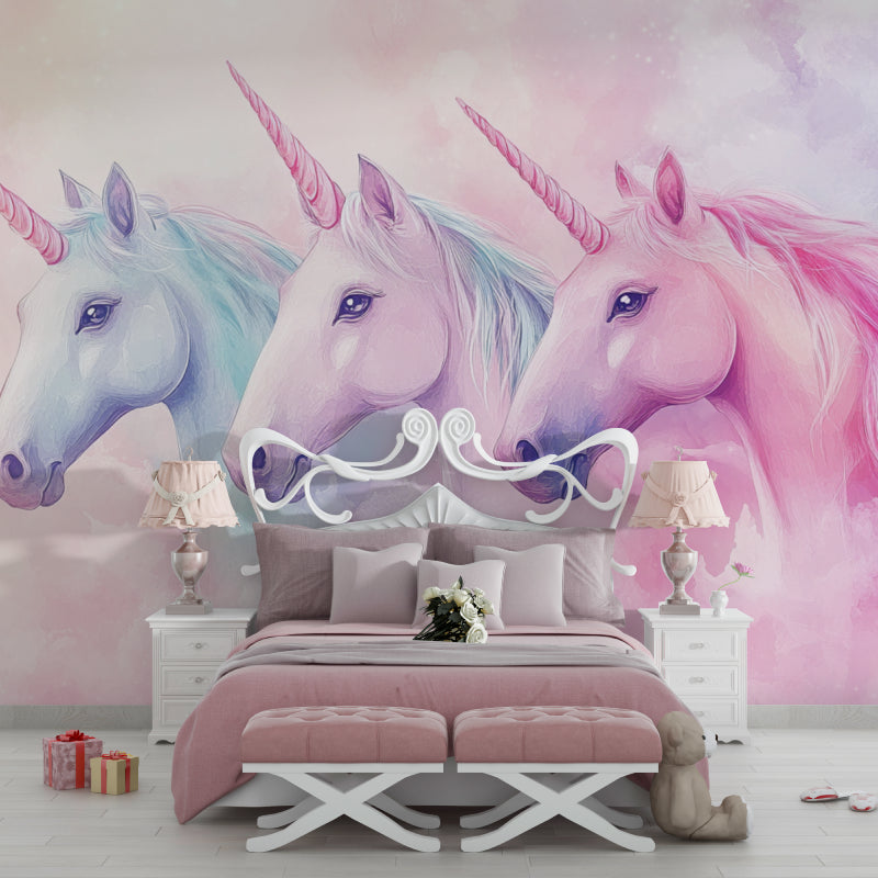 Unicorn wallpaper in a bright girl's bedroom with pink accents and white furniture