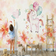 Unicorn wallpaper mural in a bright nursery, creating a magical atmosphere with soft watercolor flowers