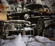 Vintage car wallpaper creating a bold statement in a modern industrial loft living room