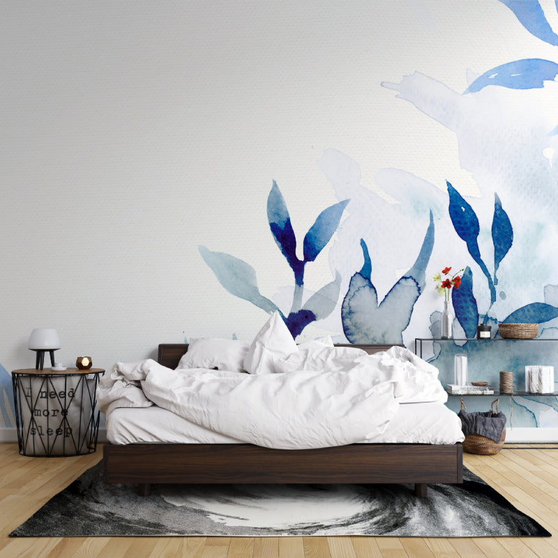 Blue watercolor botanical wallpaper in home office setting with minimal furniture
