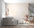 Watercolor leaf wallpaper in modern living room showing terracotta tones against white furniture