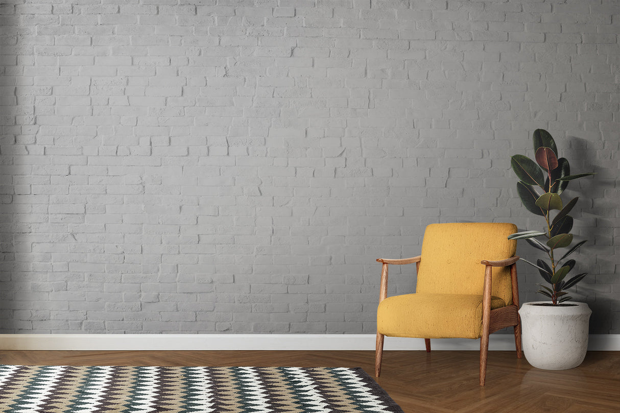 Home office space with white brick mural creating professional backdrop