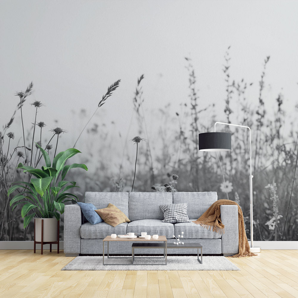 Black and white wildflower wallpaper creating a serene atmosphere in a minimalist living room with natural light