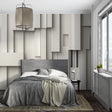 Modern 3D geometric wallpaper adding depth to a minimalist living room with grey sofa and natural light