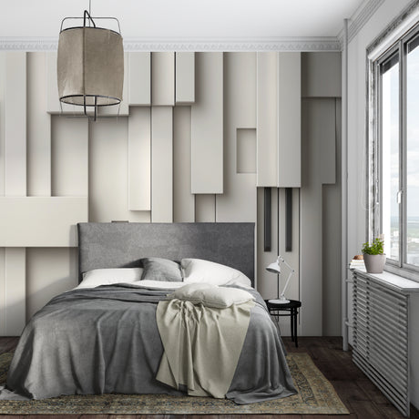 Modern 3D geometric wallpaper adding depth to a minimalist living room with grey sofa and natural light