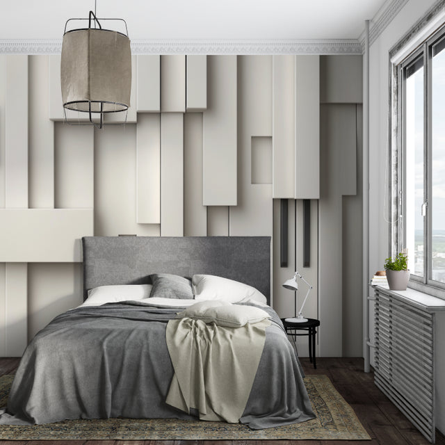 Modern 3D geometric wallpaper adding depth to a minimalist living room with grey sofa and natural light